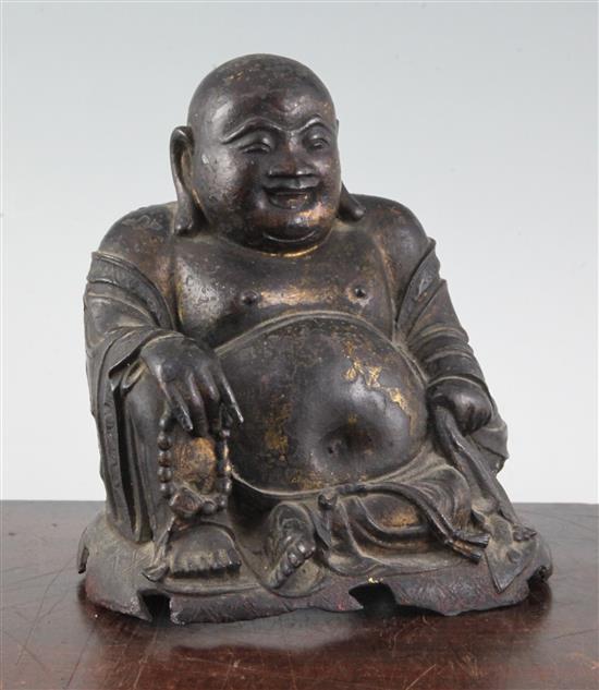 A Chinese gilt lacquered bronze seated figure of Budai, late Ming dynasty, 17cm, damage